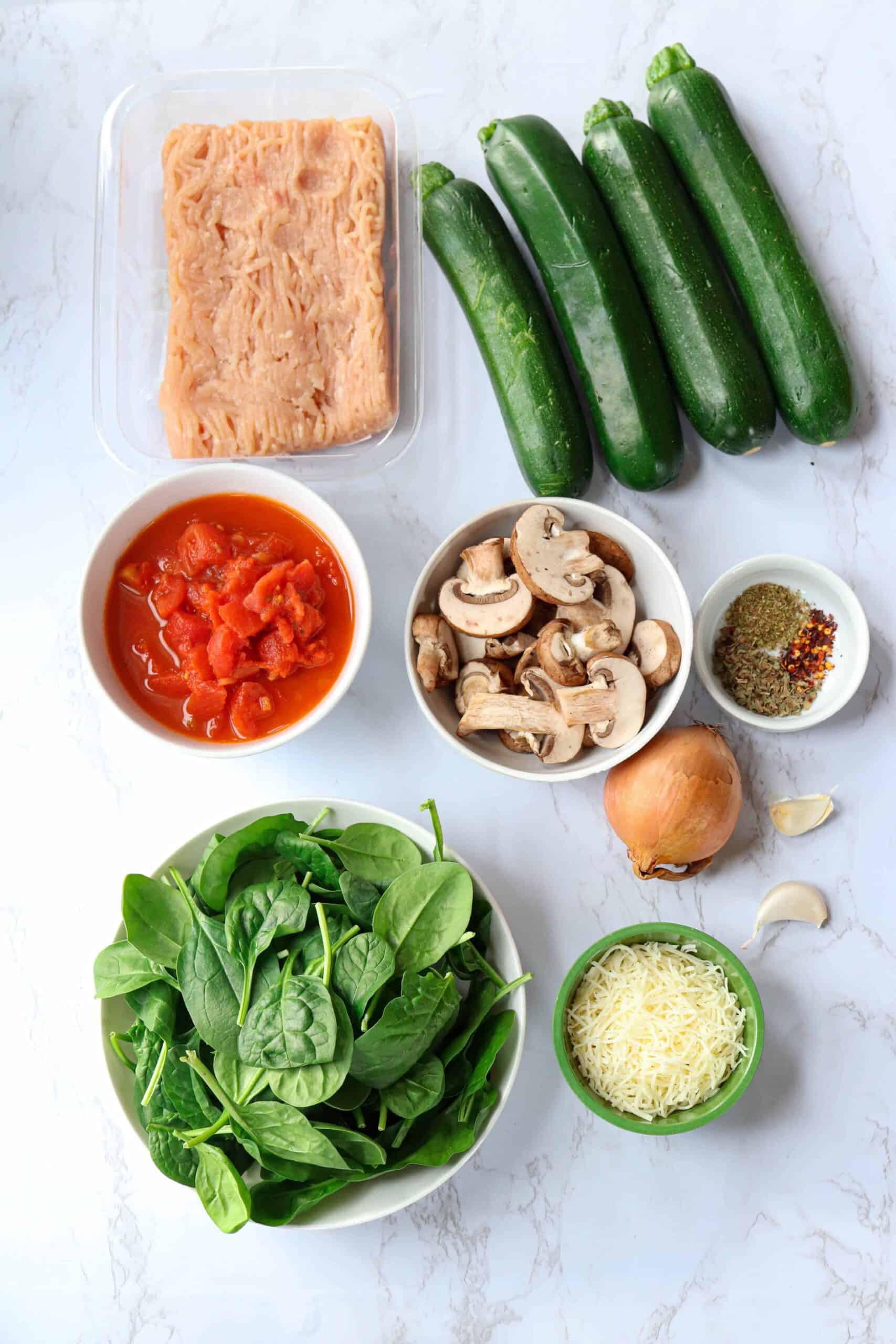 ground chicken, fresh spinach, mushrooms, four zucchini, spices, cheese, onion and garlic.