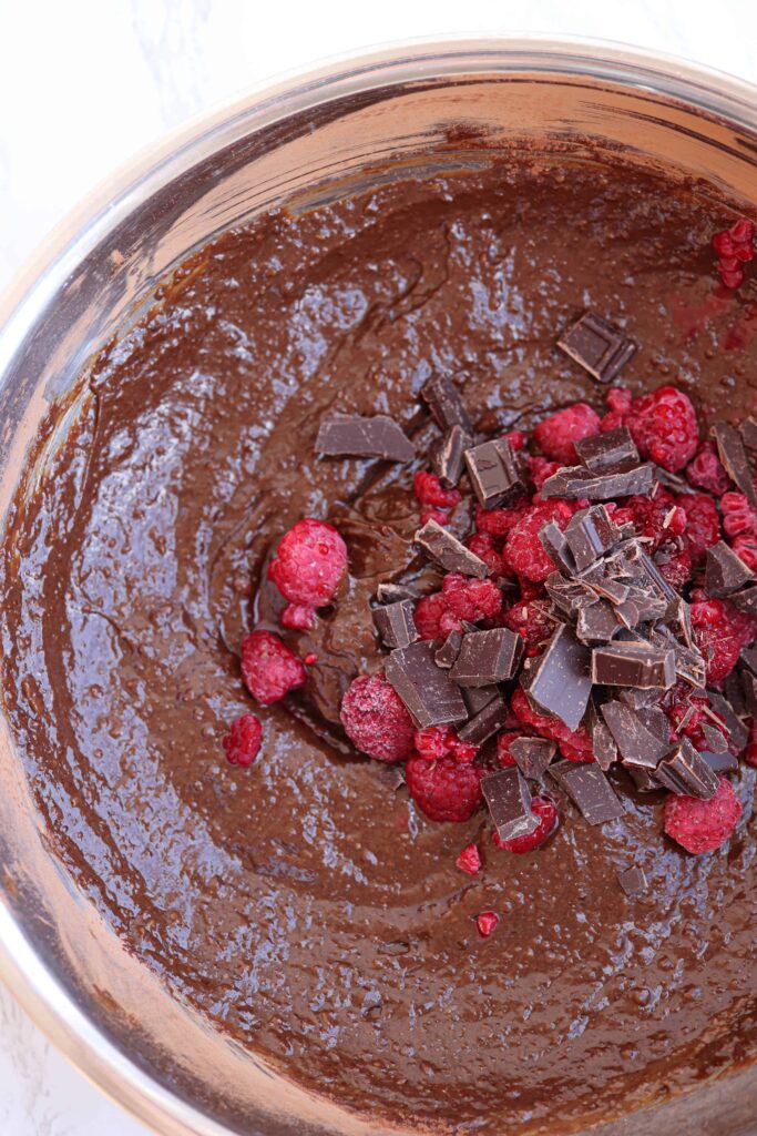 brownie batter with chocolate chunks and raspberries.