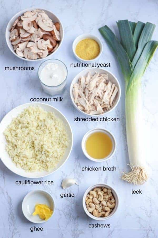 creamy chicken and mushrooms cauliflower rice casserole ingredients on white marble countertop