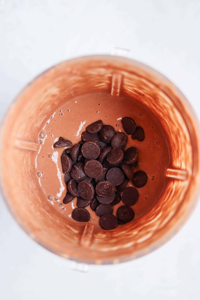blended baked oats batter with chocolate chips in a blender overhead view.