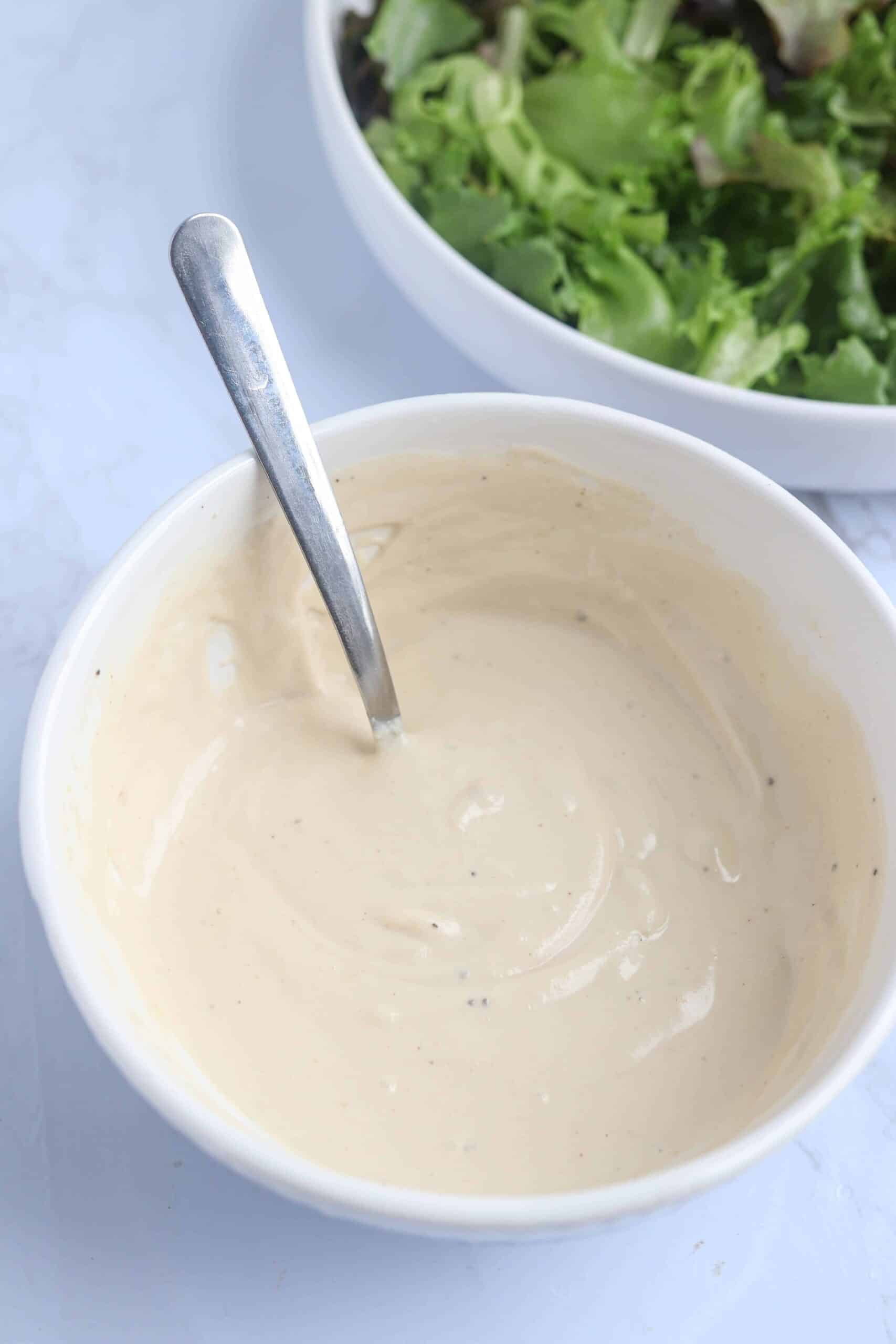 tahini dressing in a white bowl.