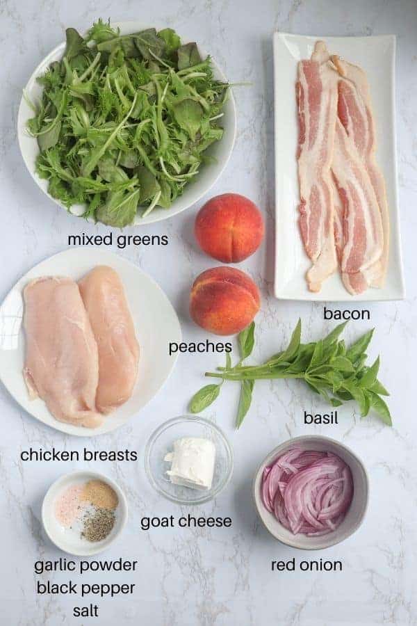ingredients for making peach bacon chicken salad on white marble surface with captions.