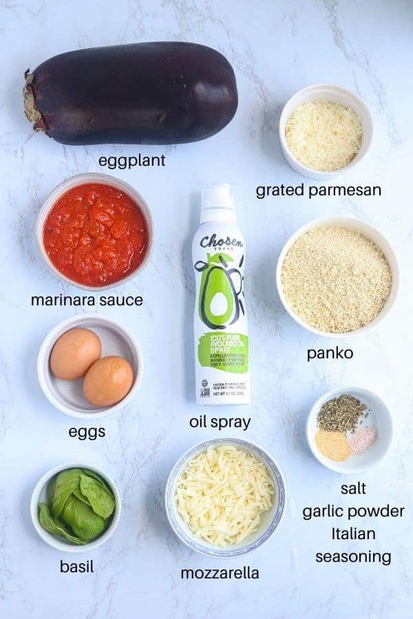 eggplant parm ingredients on white marble surface with captions.