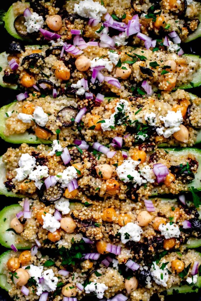 Greek stuffed zucchini stuffed boats with quinoa, chickpeas, red onions and feta cheese.