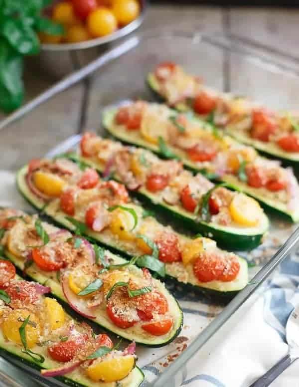 zucchini boats stuffed with hummus and tomato bruschetta.