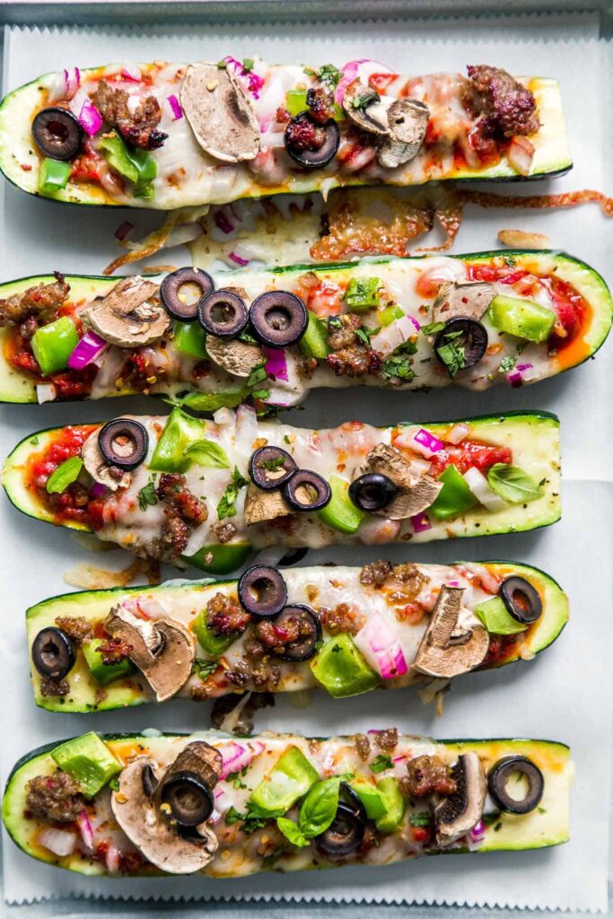 pizza stuffed zucchini boats with mushrooms and olives.
