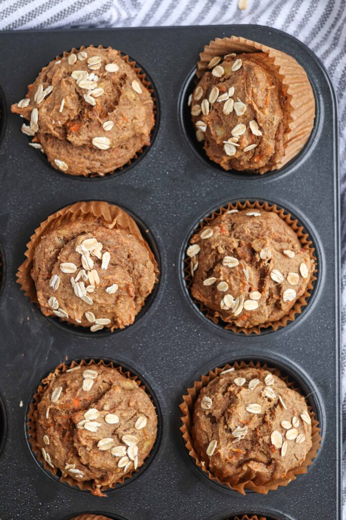 banana carrot oat muffins in a black muffin tin