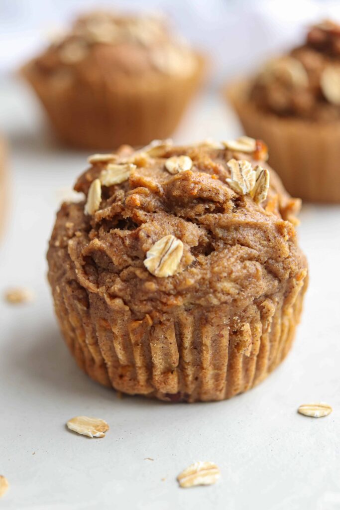 banana carrot oat muffins on light gray surface.
