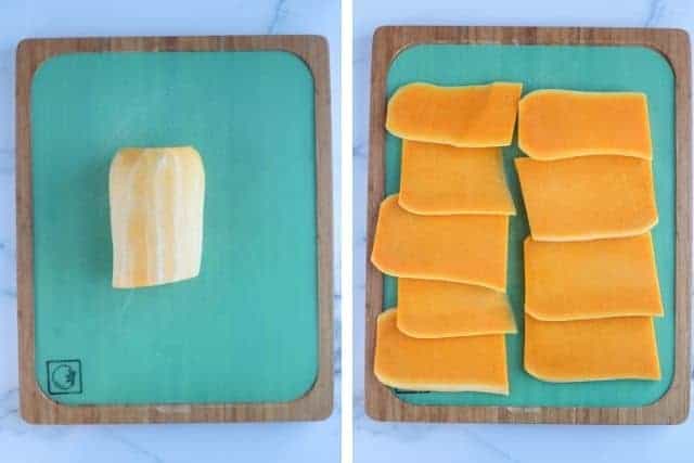 slicing butternut squash on a green cutting board in two steps.