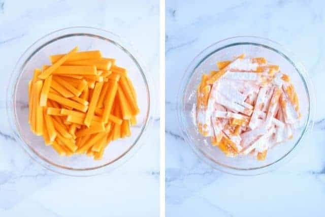 dusting butternut squash fries with corn starch in a glass bowl in two steps. 