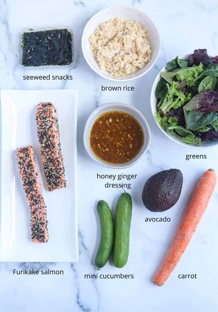 furikake salmon bowl ingredients laid out on white marble surface with captions