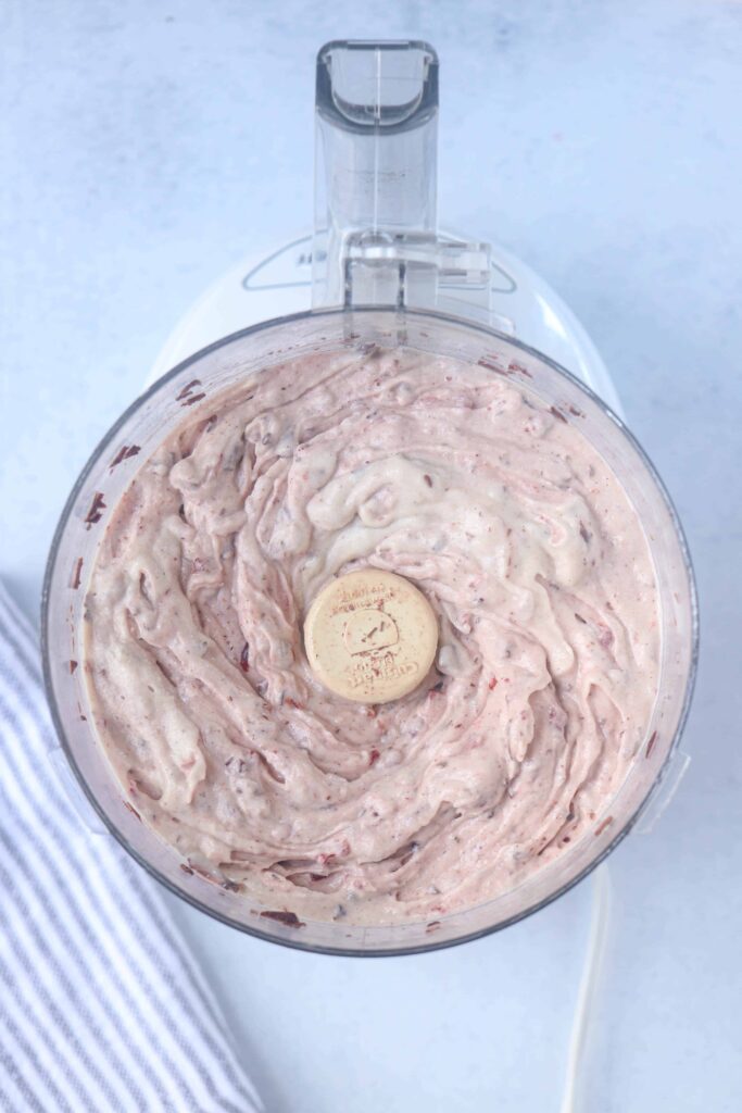 making cherry chocolate banana nice cream in the food processor.