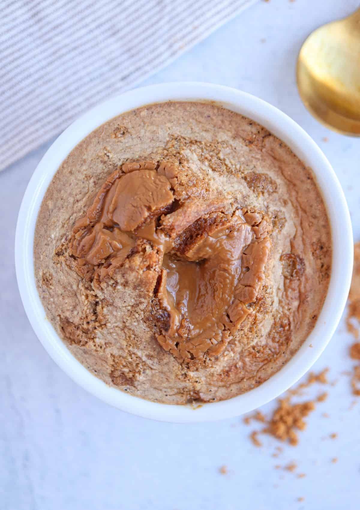 blended Biscoff baked oats in a white ramekin.