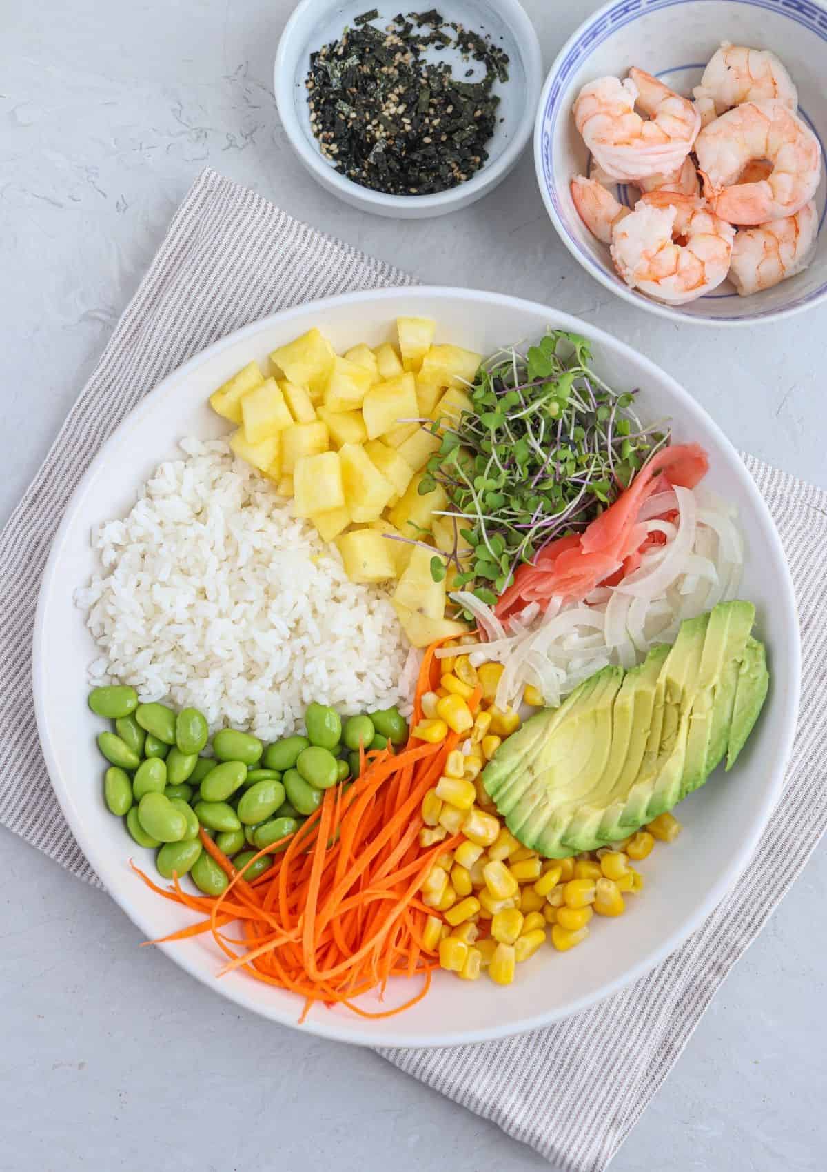 making shrimp poke bowl in a white bowl.