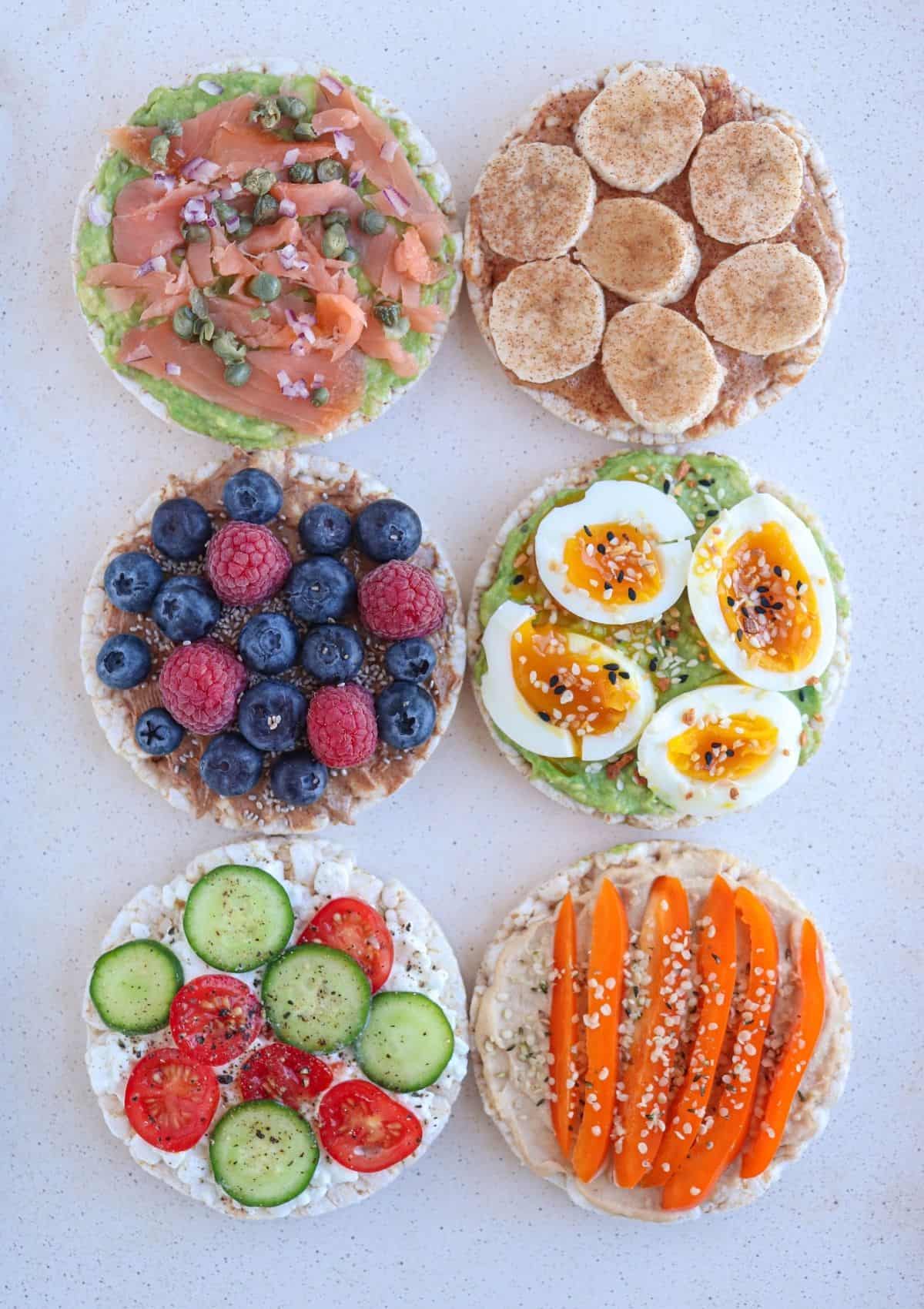 six different kinds of open face sandwiches on round rice cakes, sweet and savory.