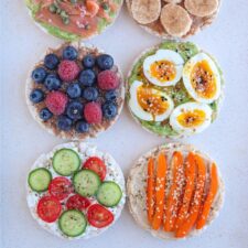 six rice cake snacks with various toppings.