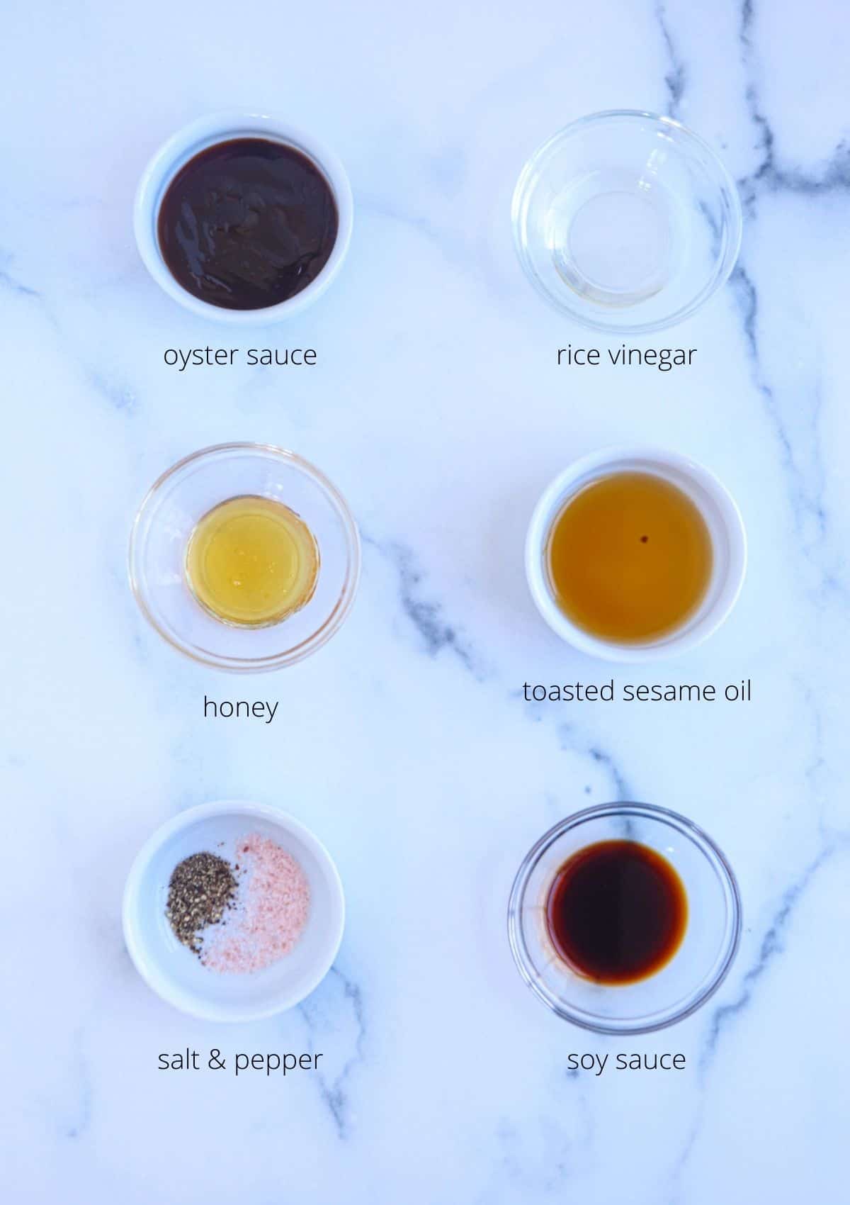 yaki udon sauce ingredients in small bowls on white marble surface with captions. 