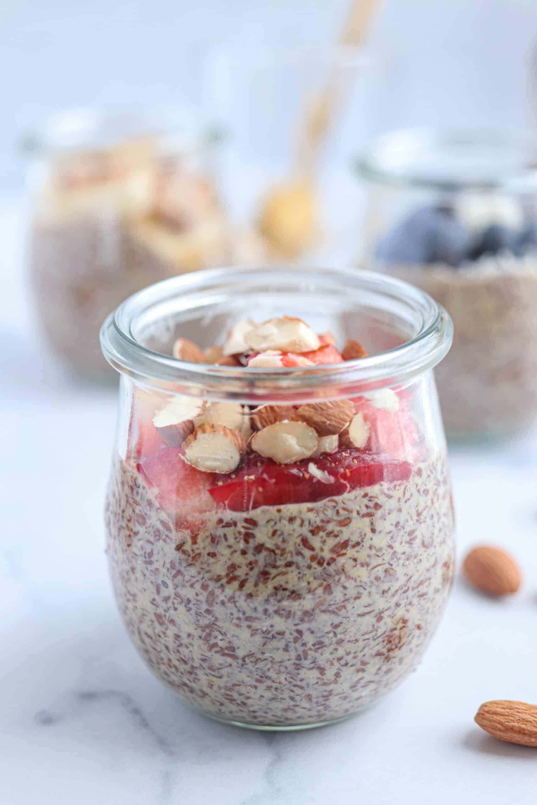 flaxseed pudding with strawberries and almond in a glass tulip jar.
