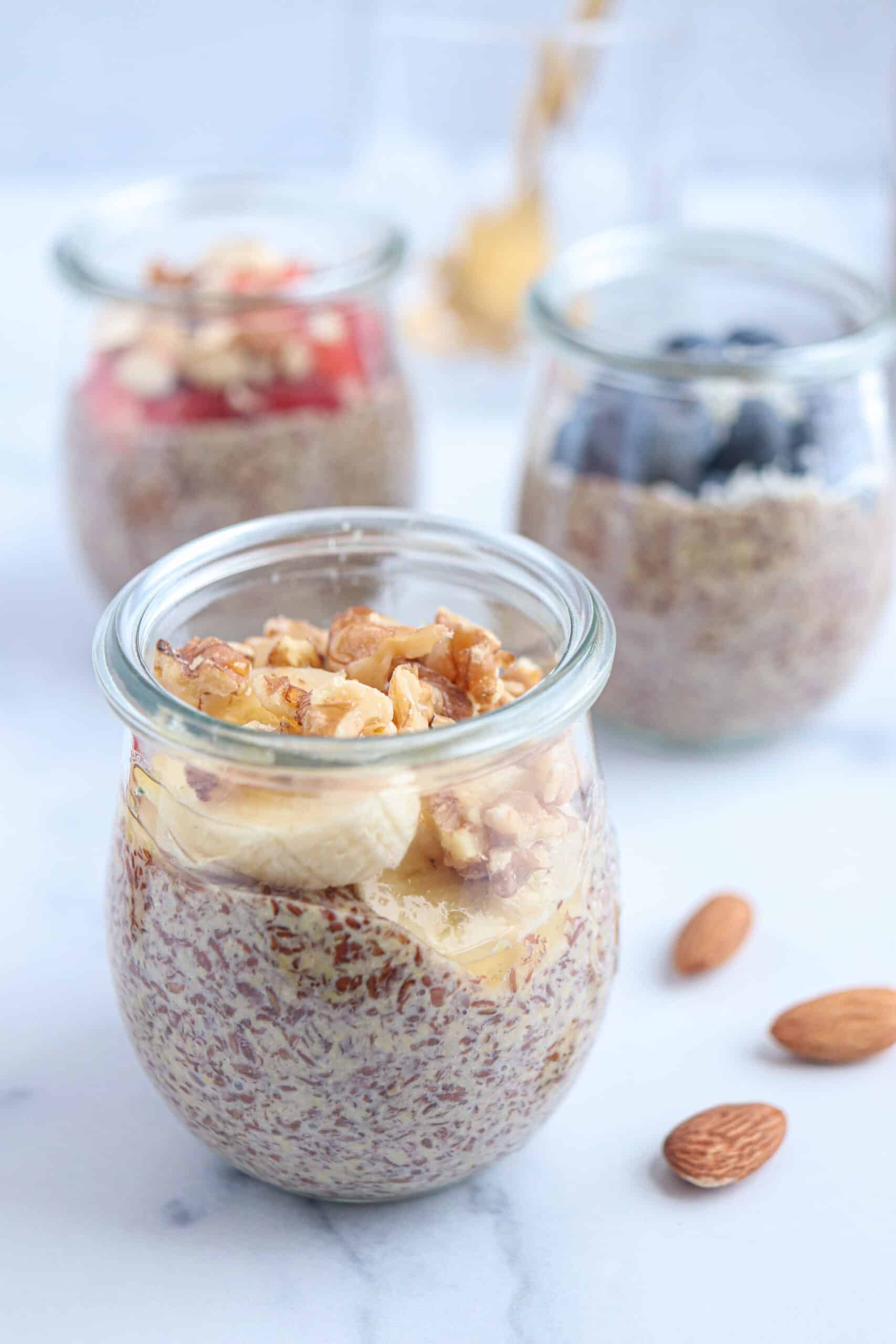 flaxseed pudding with bananas and walnuts in a glass tulip jar.