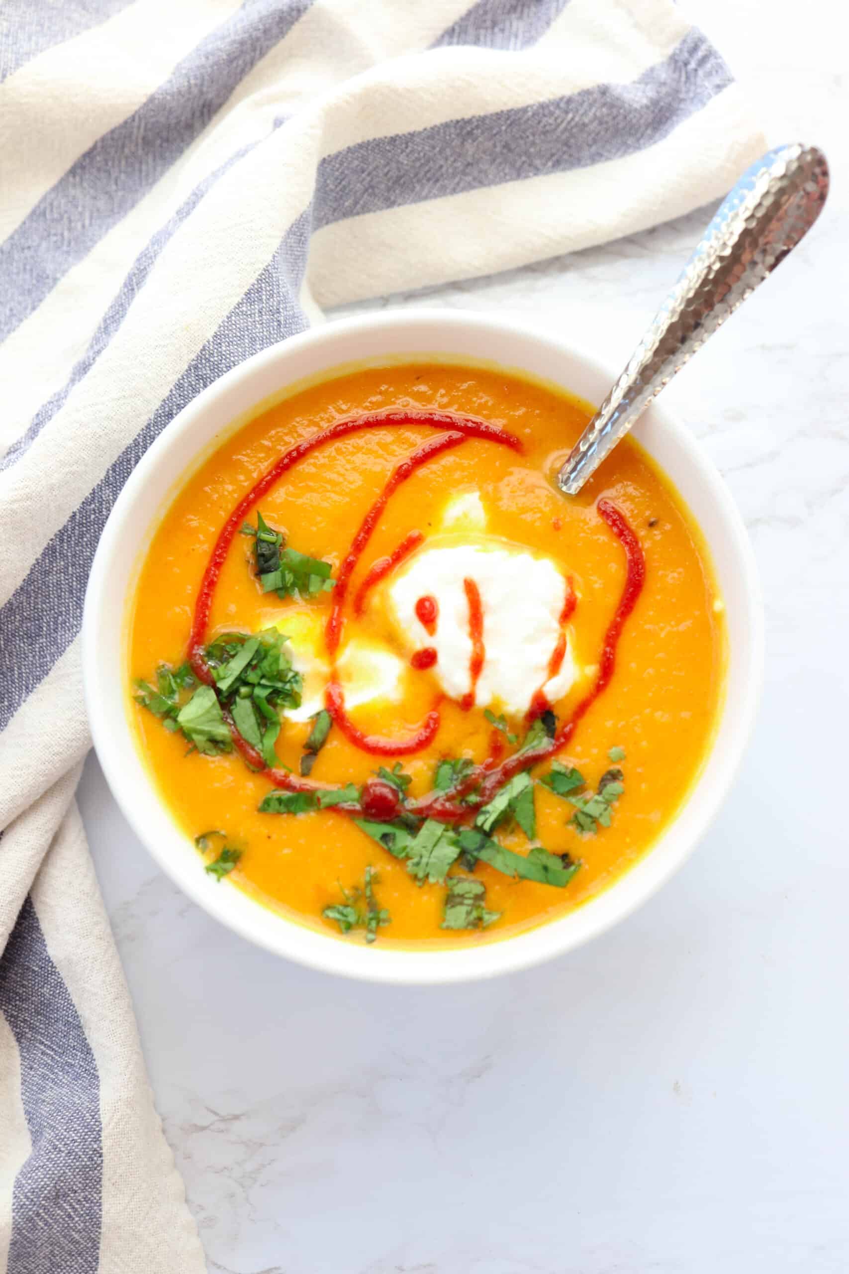 butternut squash carrot ginger soup with a glob of yogurt, sriracha and chopped cilantro.