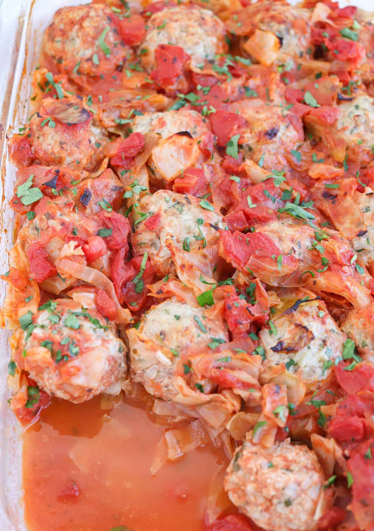 cabbage and meatballs in a casserole dish, close up.