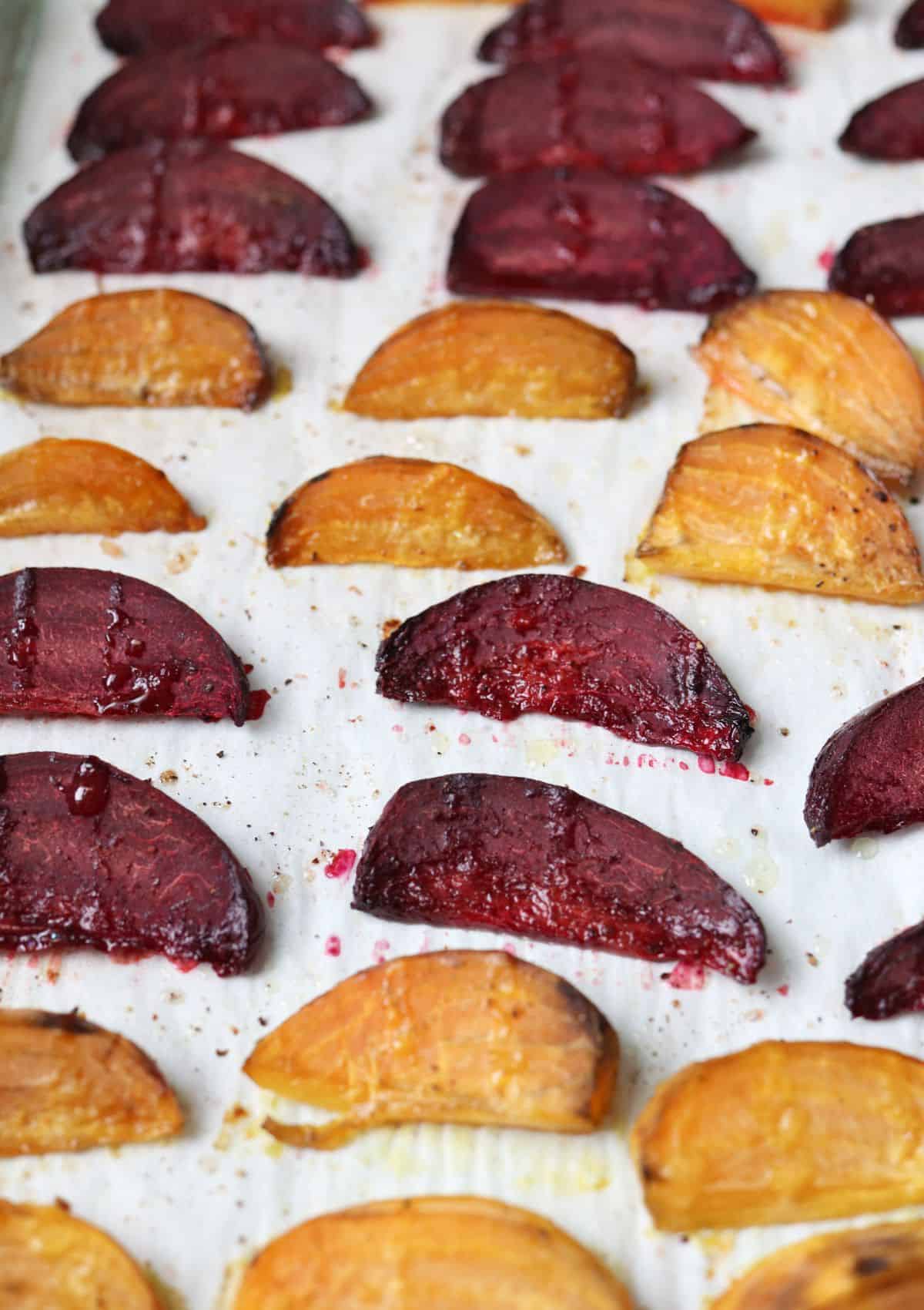 roasted beet wedges on paper lined baking tray.