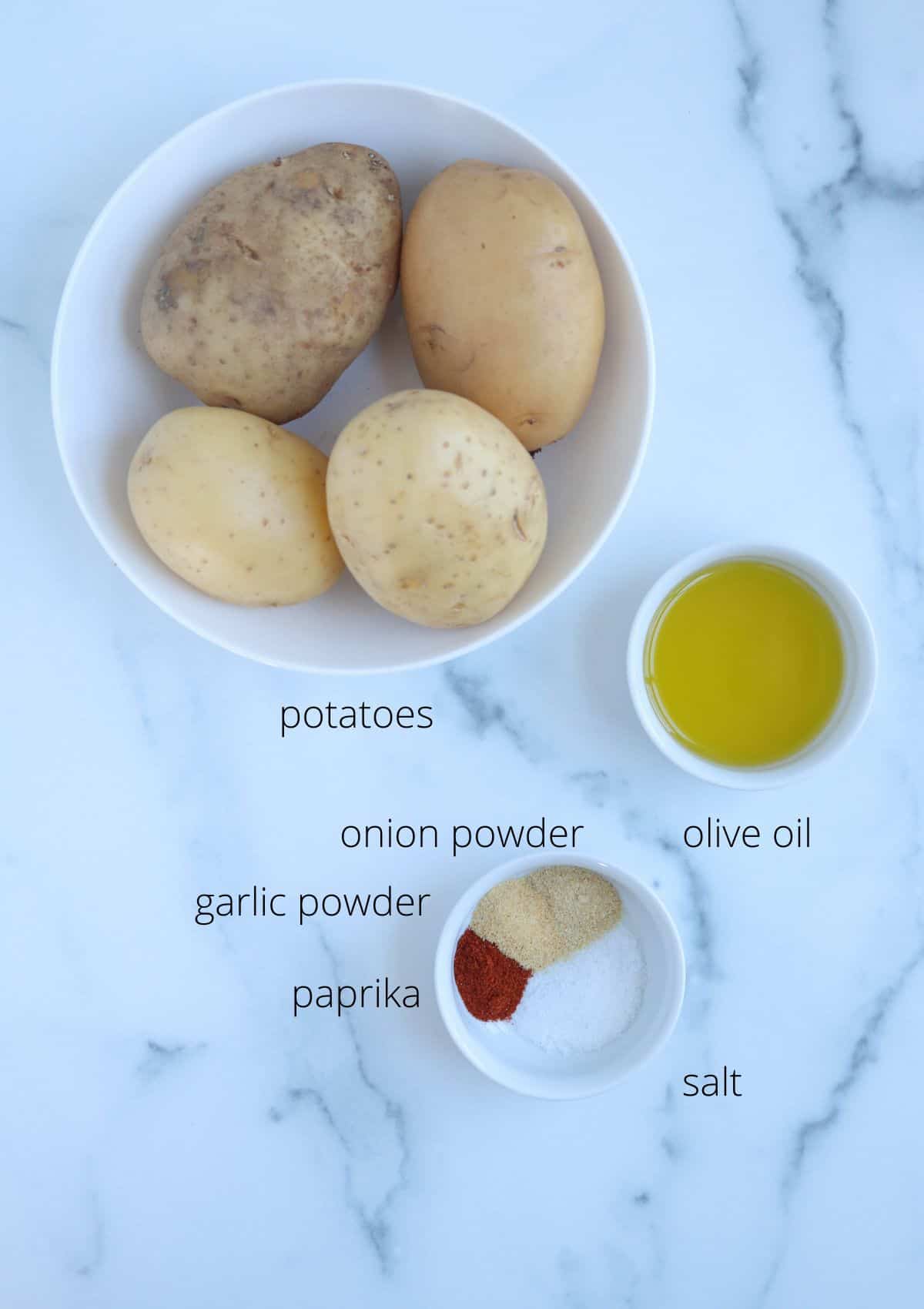 ingredients for making air fried potato slices on white marble surface with captions. 