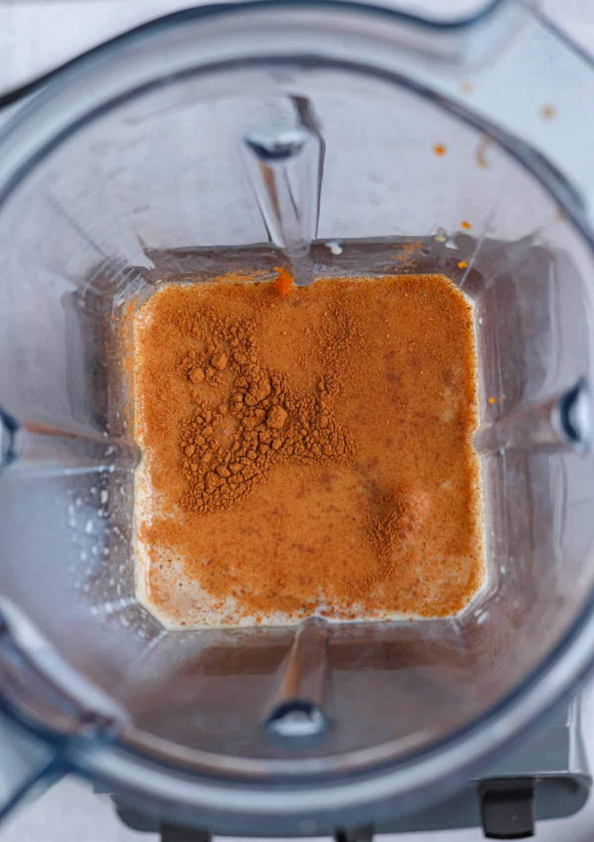 making iced pumpkin spice latte in a blender, before blending.