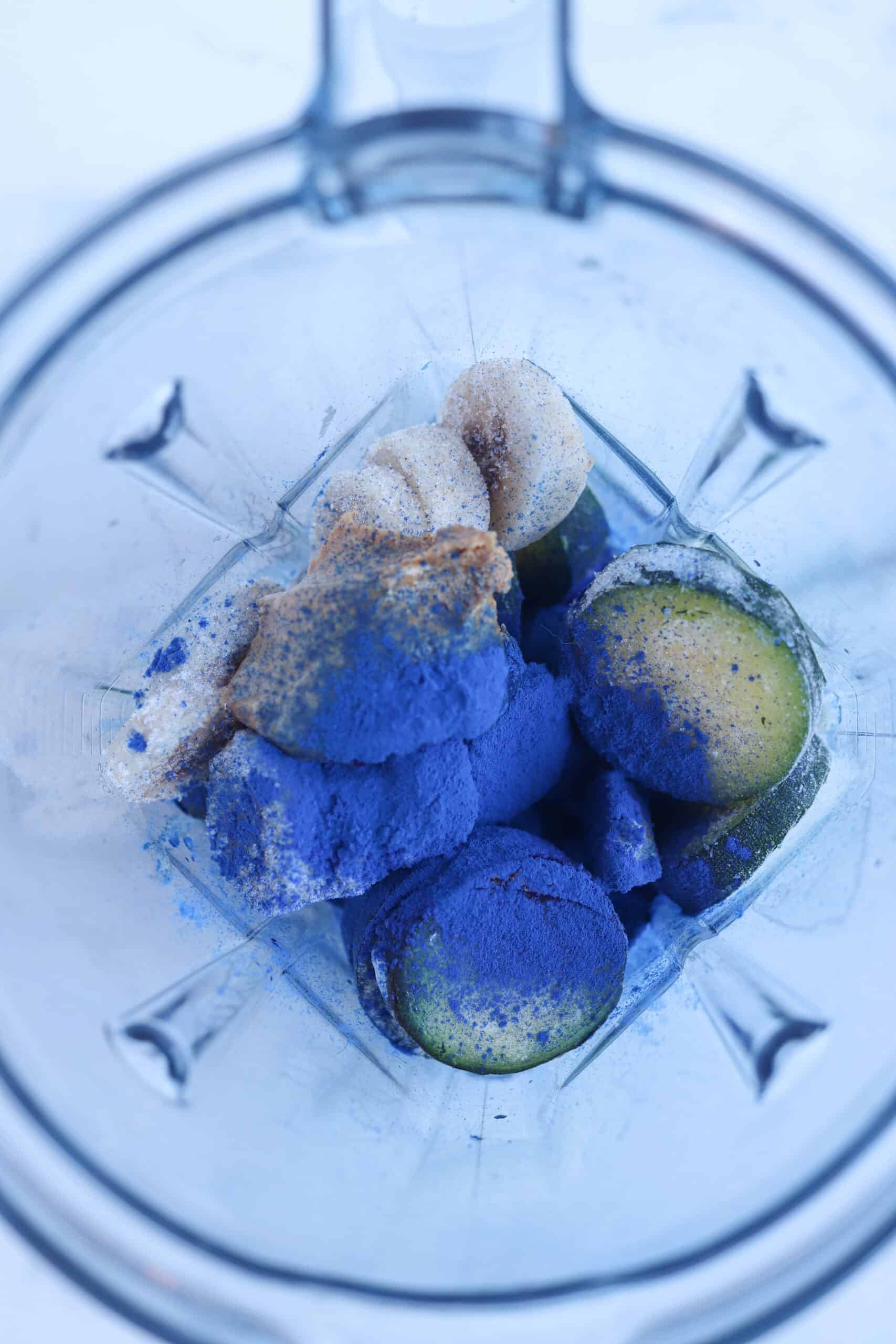 blue spirulina ingredients in a high powered blender, overhead look.