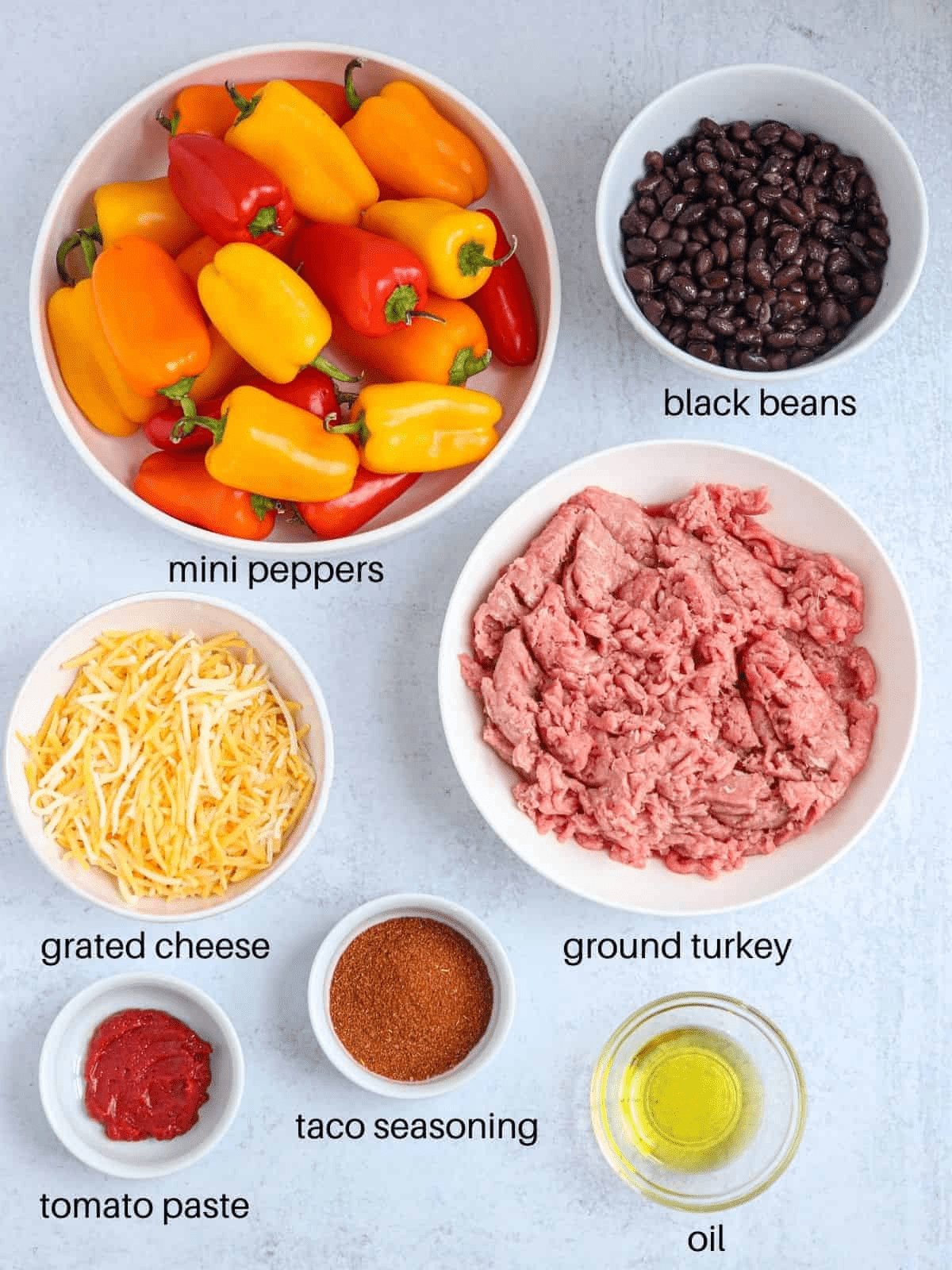 mini pepper nachos ingredients in containers on light gray surface with captions.