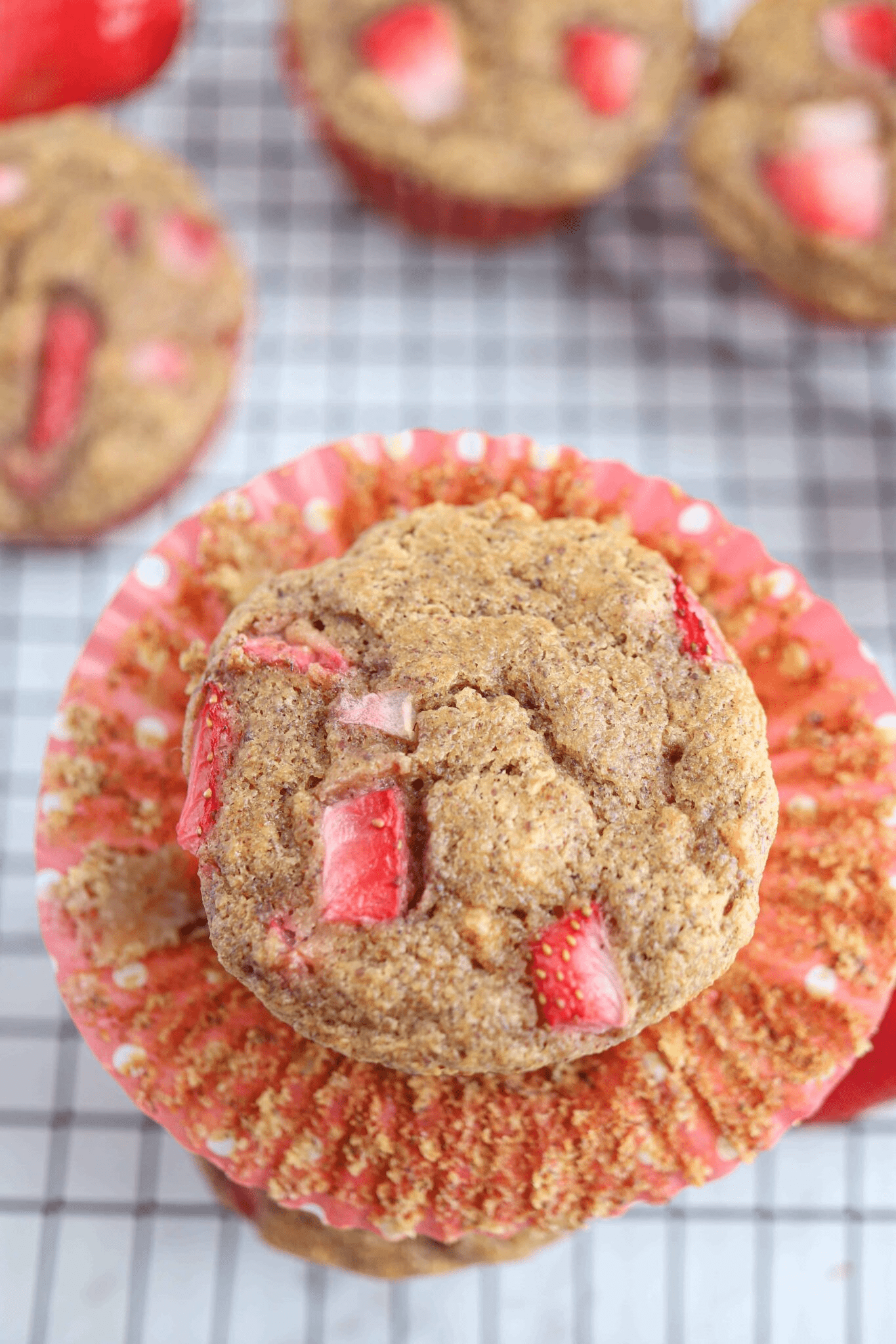strawberry muffin in an unwrapped muffin wrapper.