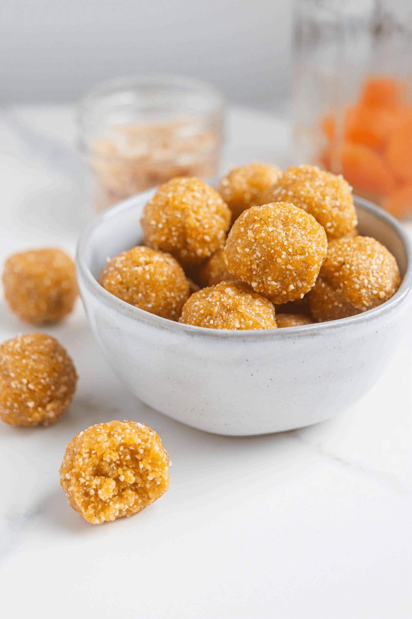apricot bliss balls in a small gray bowl.