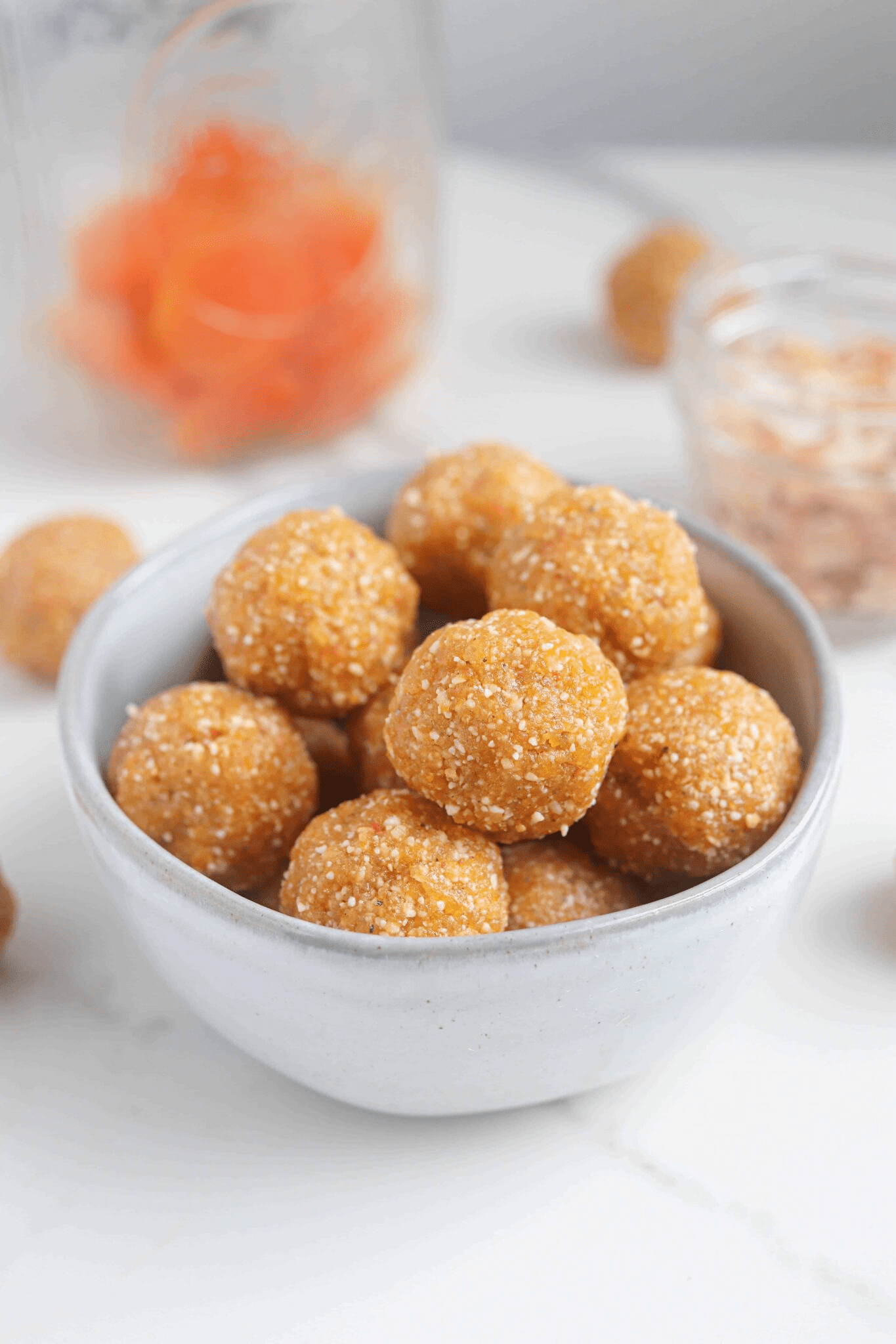apricot bliss balls in a small gray bowl.