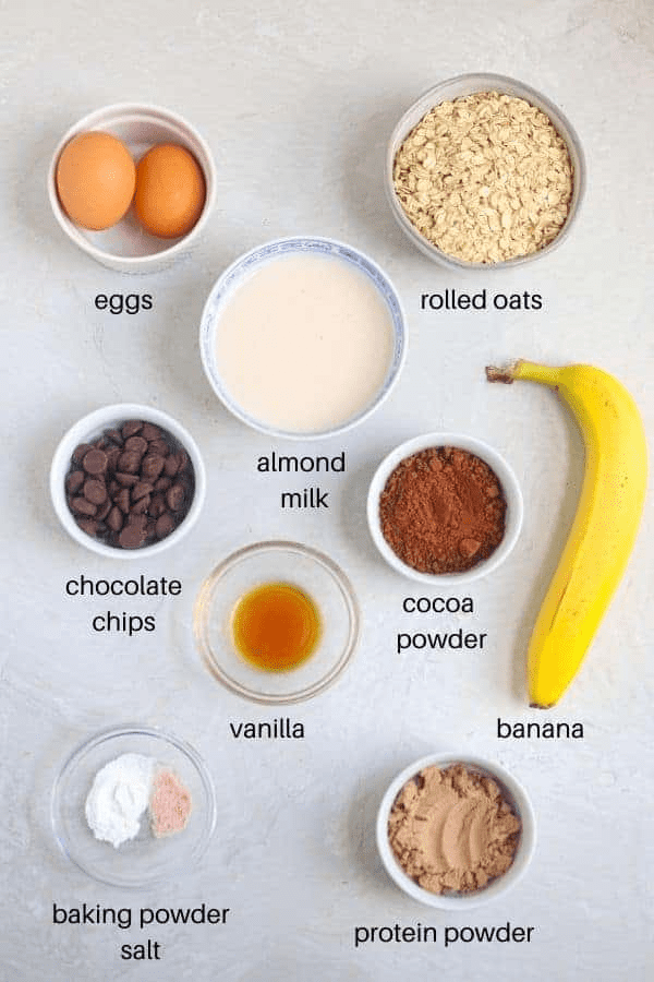 chocolate protein baked oats ingredients in round containers with captions. 
