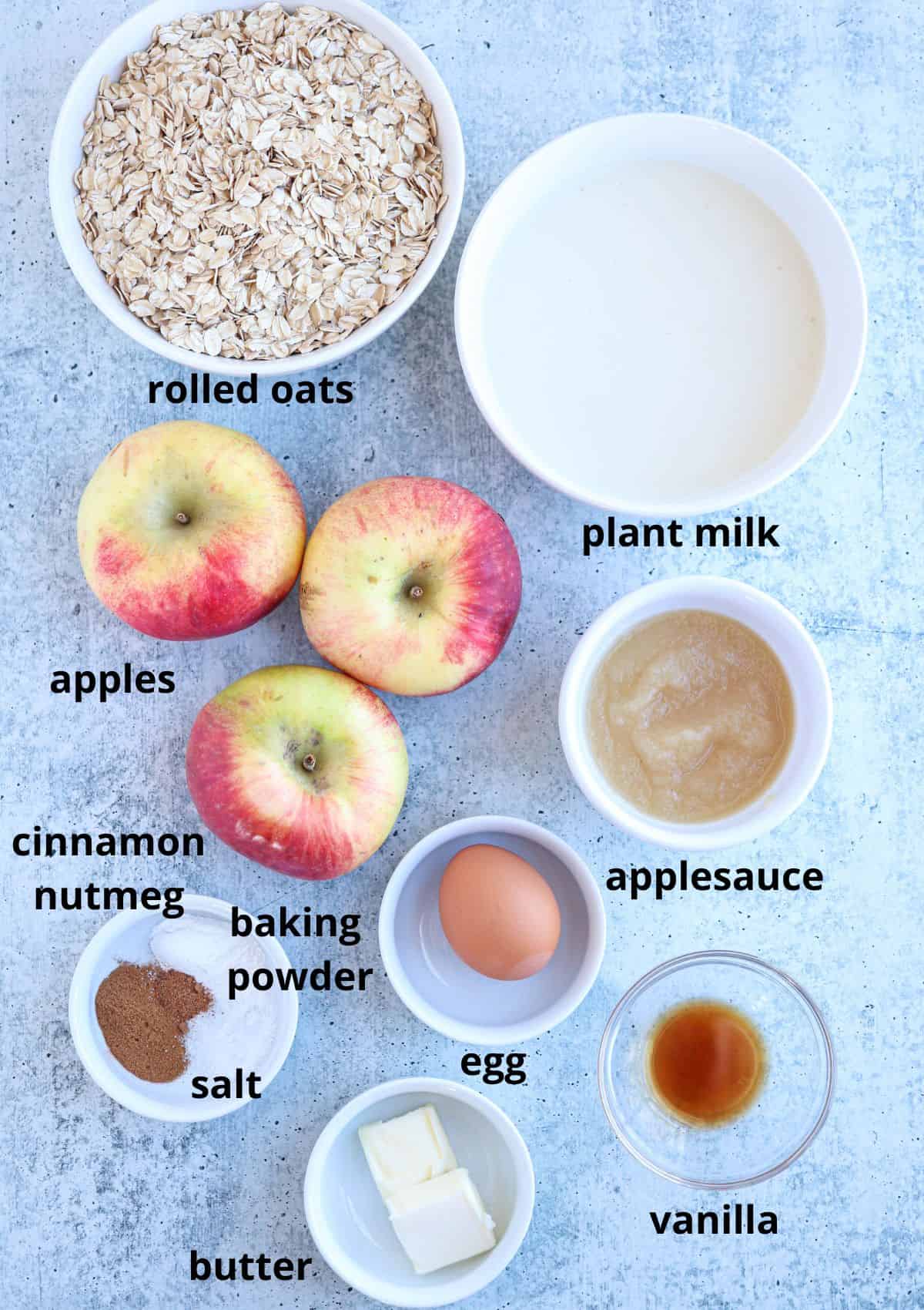 baked apple pie oatmeal ingredients on gray surface in small containers with captions. 