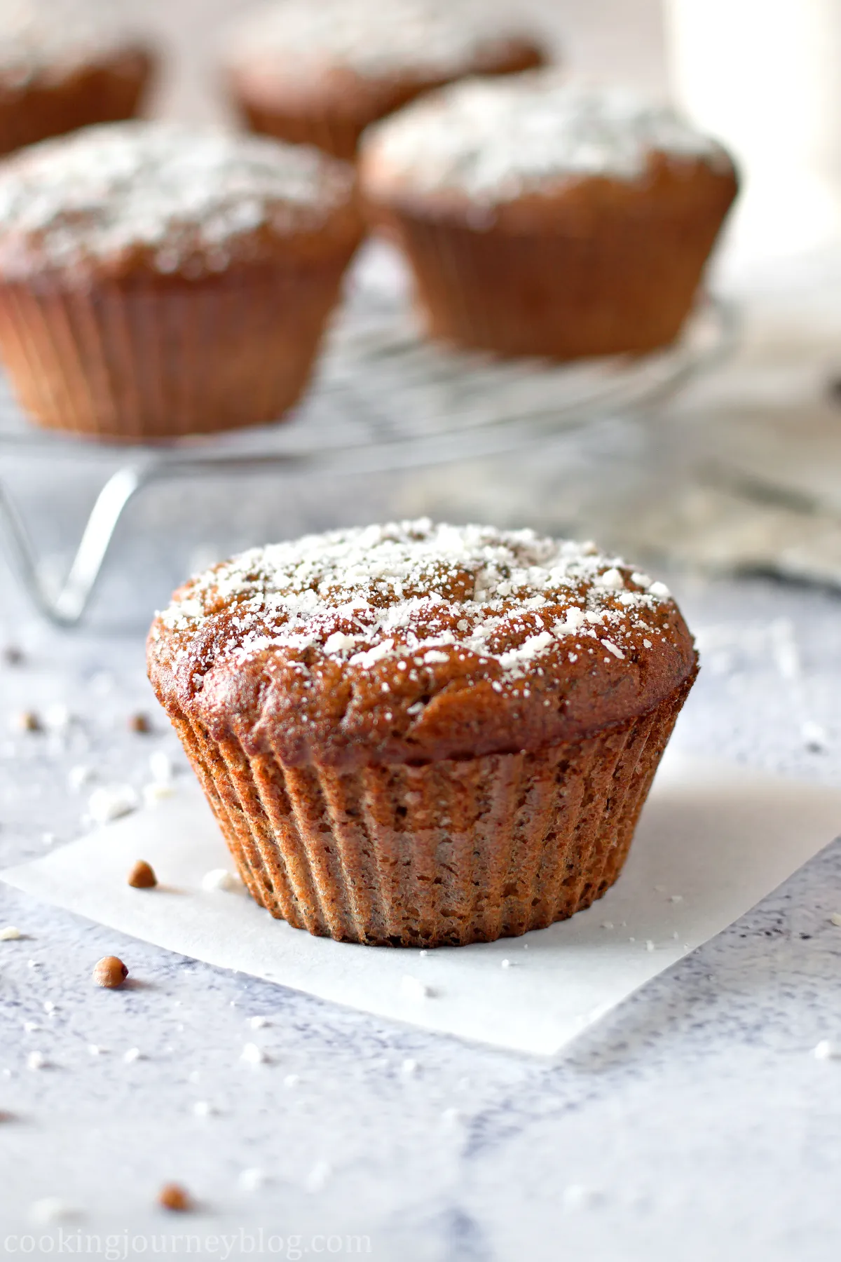 banana buckwhet muffin dusted with powdered sugar.