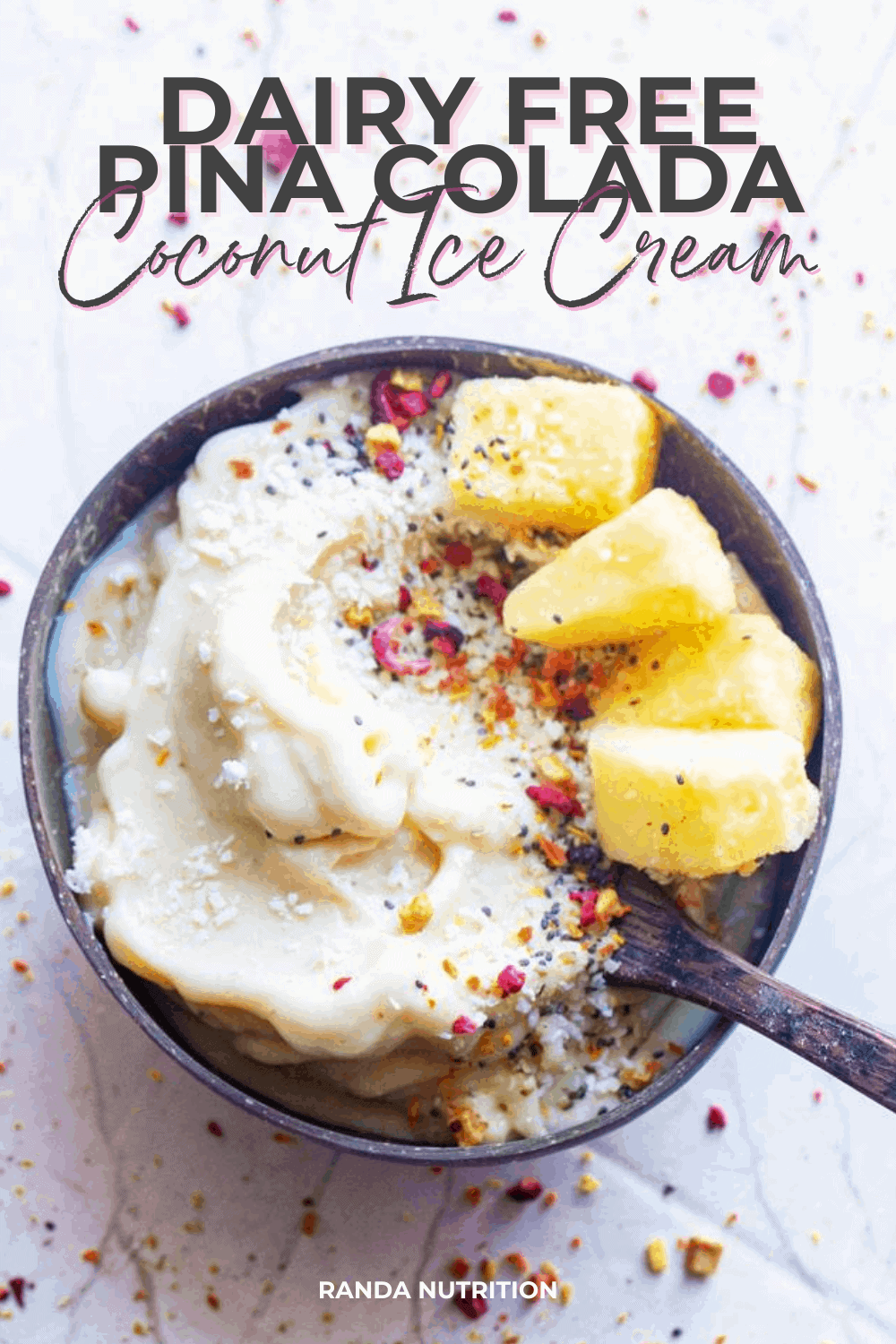 pina colada ice cream made with bananas topped with frozen pineapple in a coconut bowl.