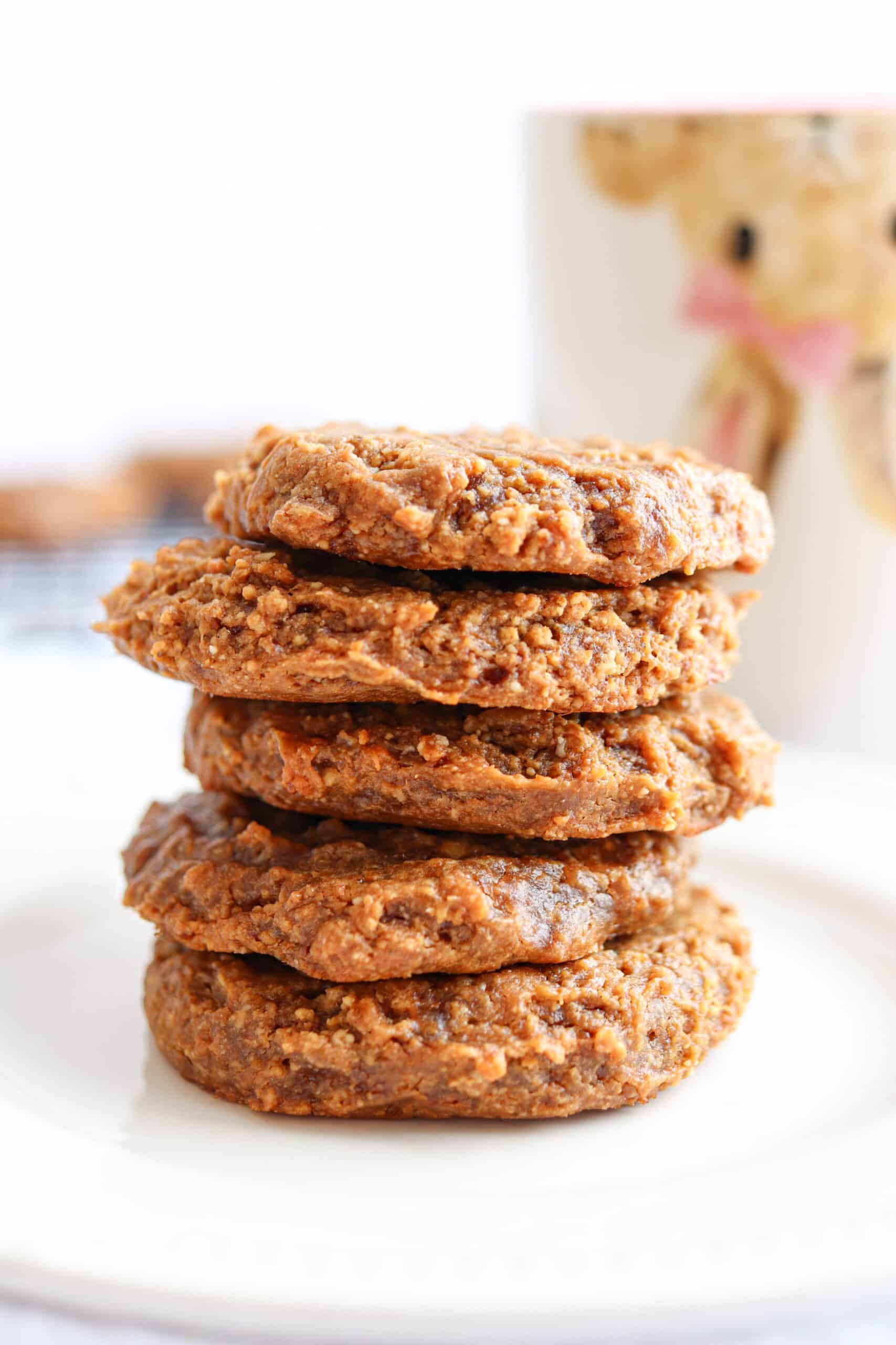 banana peanut butter cookies stacked on a white plate.
