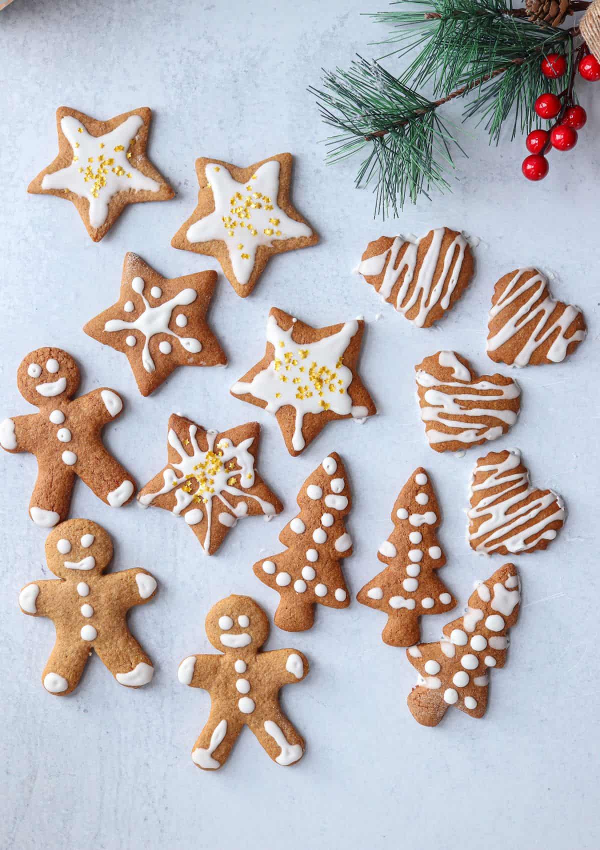 Polish gingerbread cutout cookies with white  royal icing and golden star sprinkles.