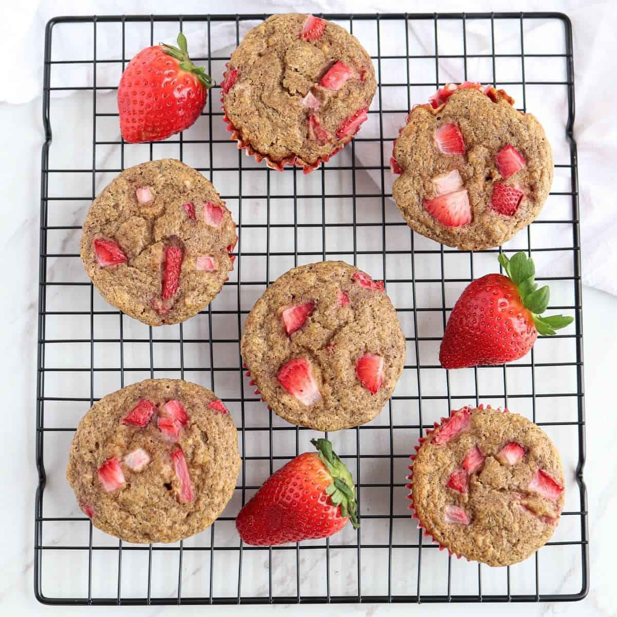 strawberry banana oatmeal muffins on a black cooling rack.