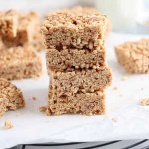 a stack of rice krispie treats made with almond butter on white paper.