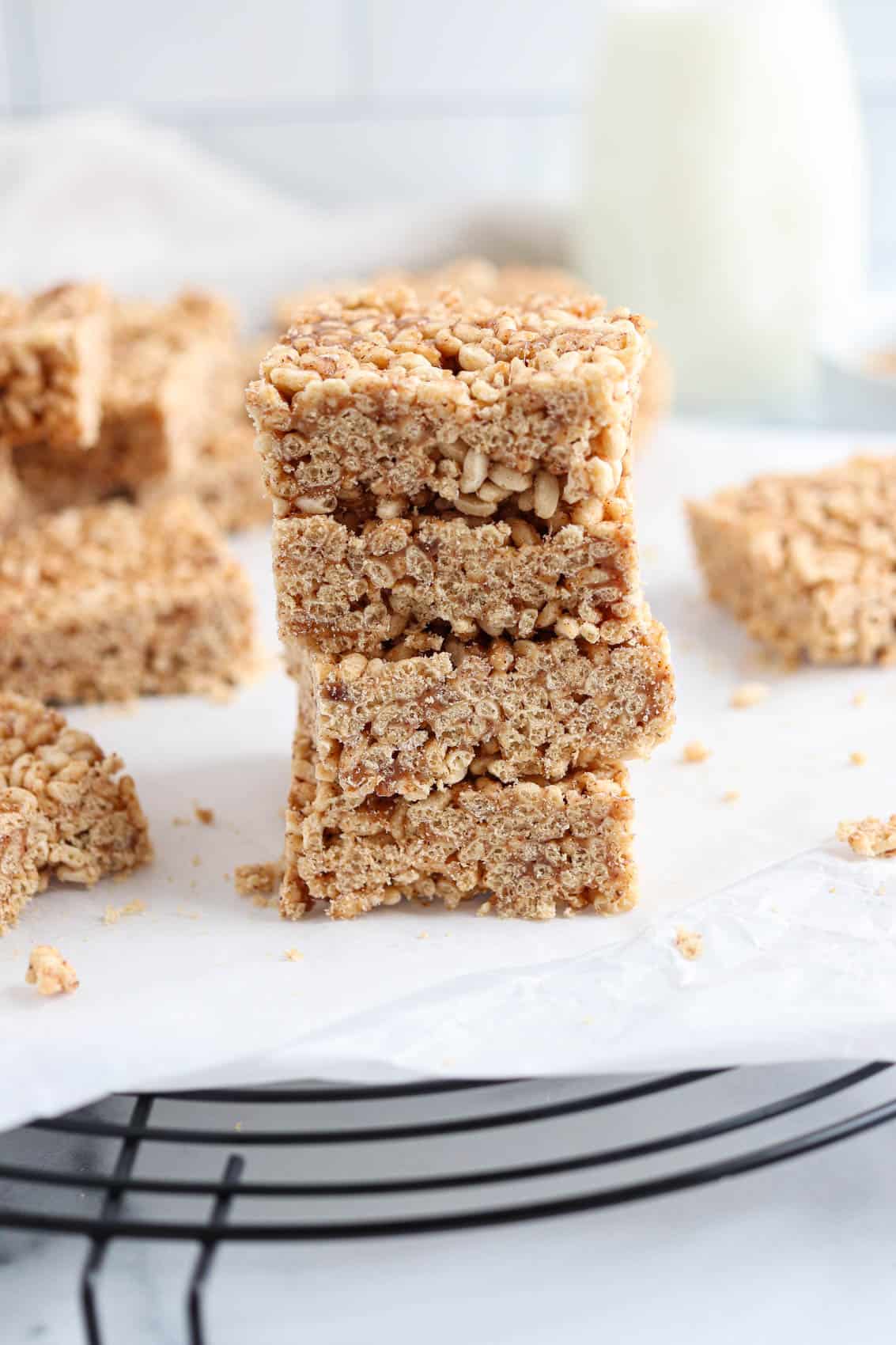 a stack of healthy rice krispie treats on white wax paper.