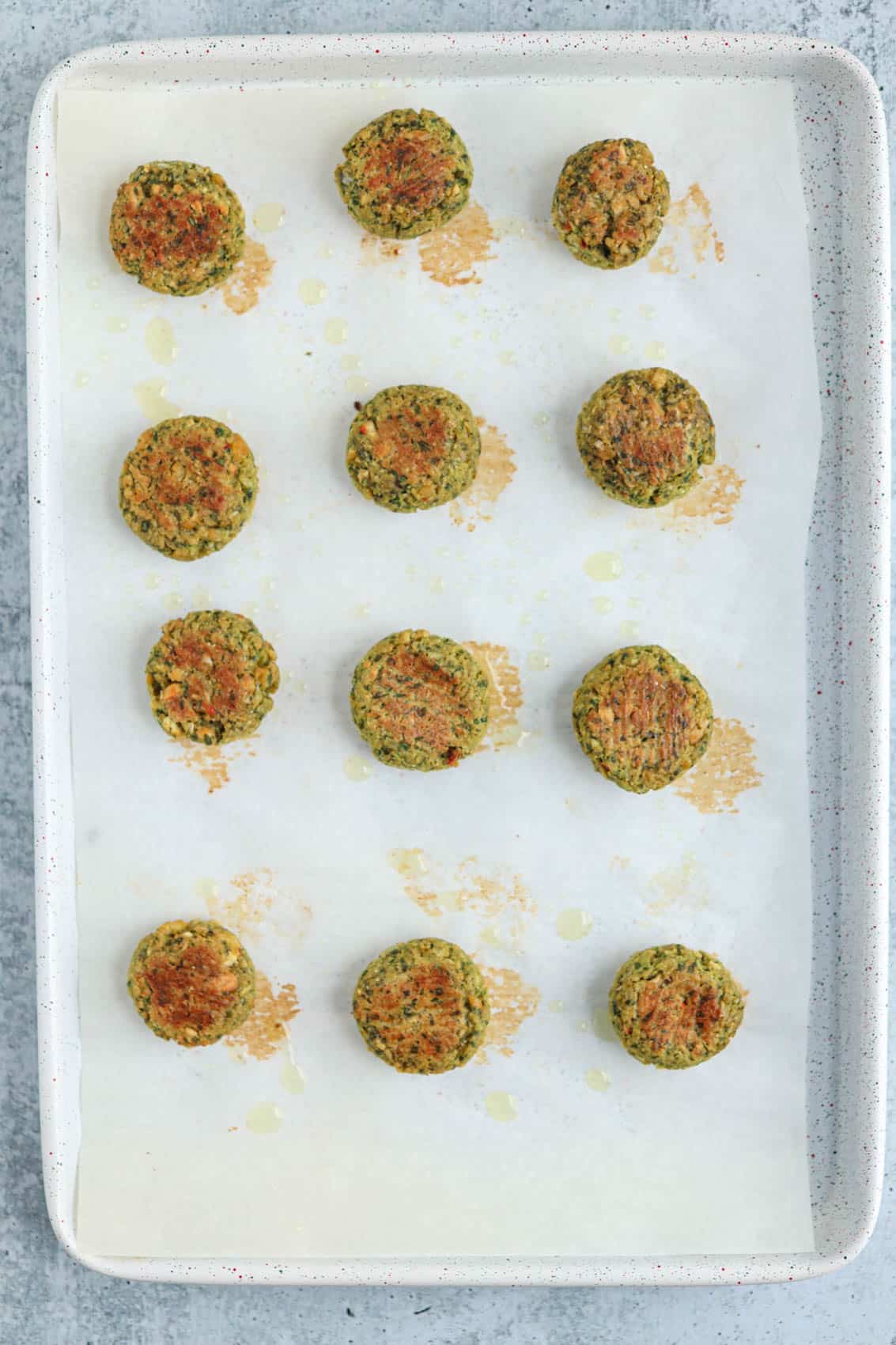 baked falafel patties on a baking sheet.