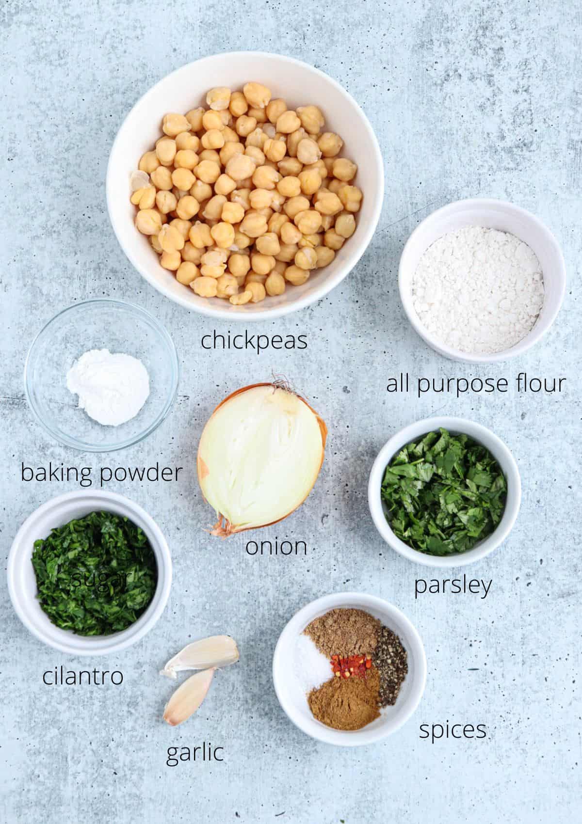 ingredients for making air fryer falafel on gray surface with captions.
