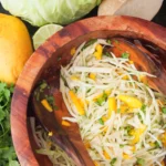 mango jicama slaw in a wooden bowl.