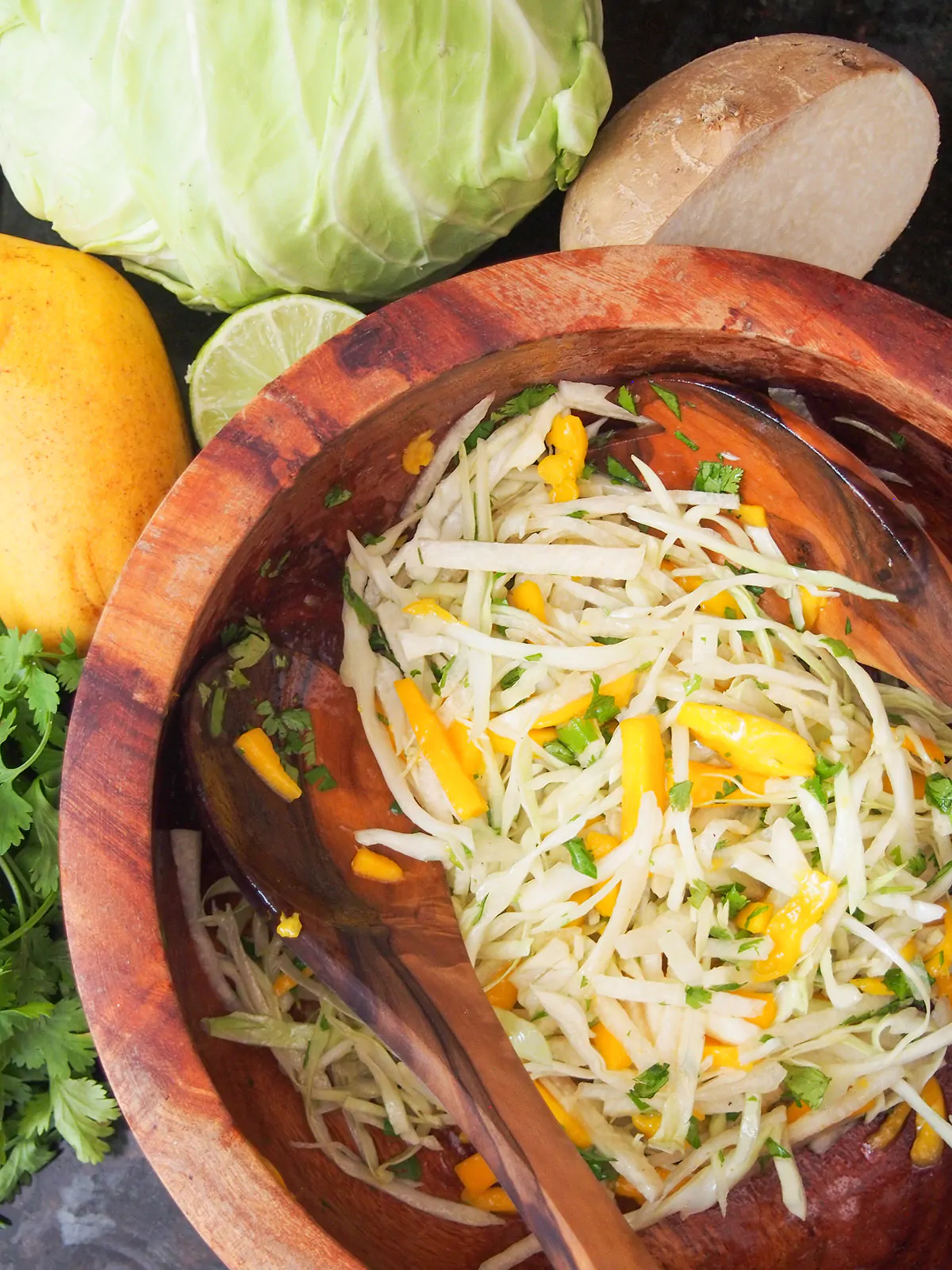 mango jicama slaw in a wooden bowl.