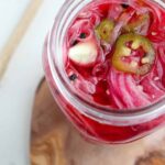 Mexican pickled onions in a glass jar.