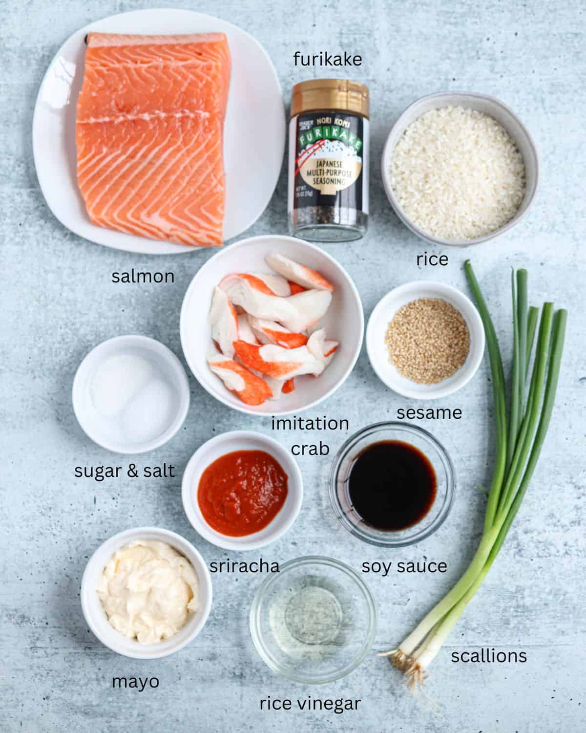 ingredients for making salmond sushi bake in containers on gray surface with captions.