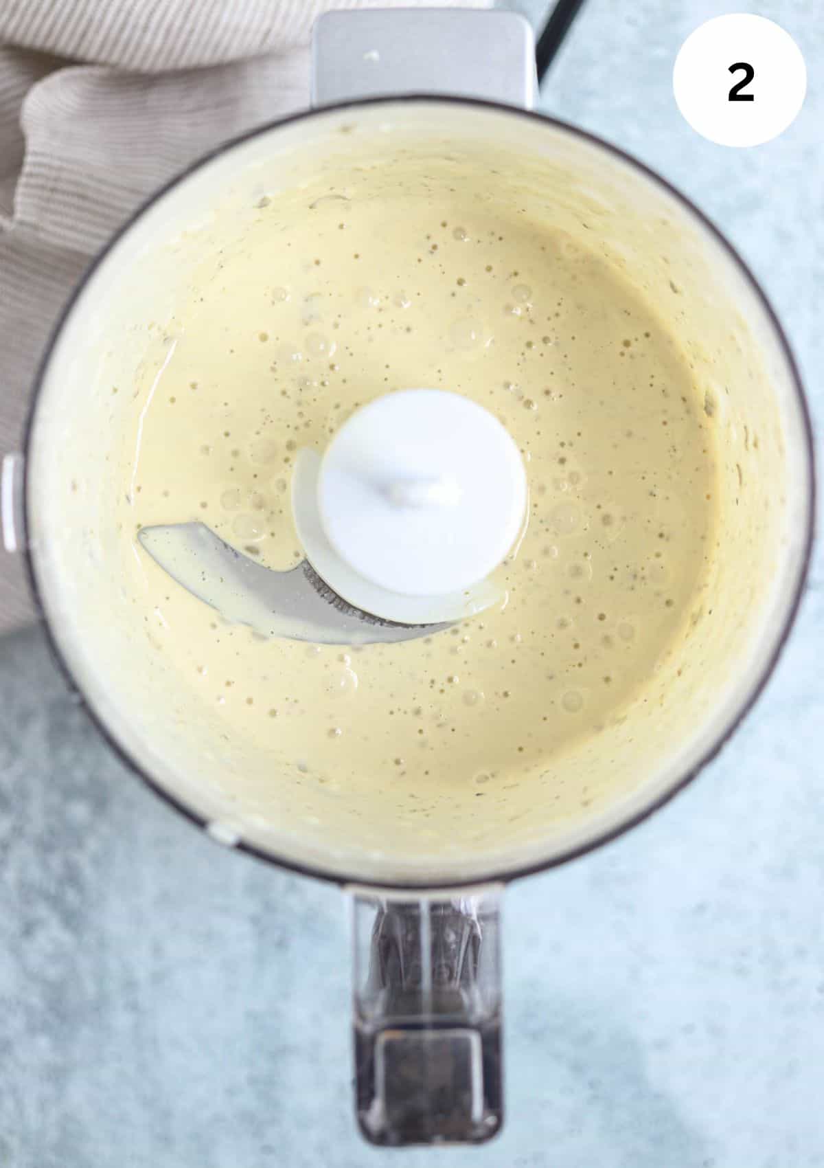 making caesar salad dressing in a mini food processor.