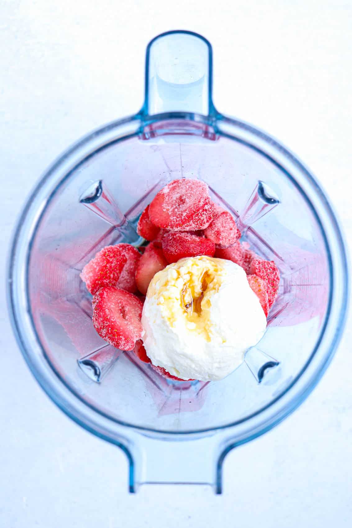 strawberries, yogurt and maple syrup in a blender.